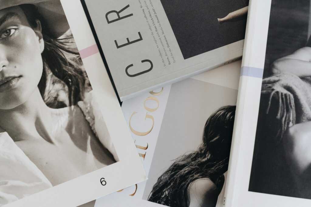 A close-up view of artistic and fashion magazines laid out on a table.